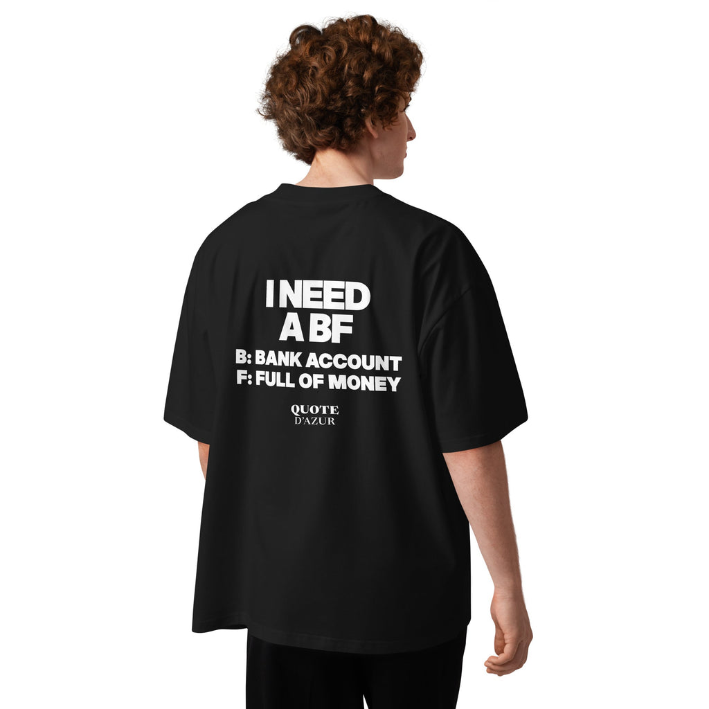 I Need a BF: Bank Account, Full of Money – Oversized T-Shirt in Black, back view on a male model.