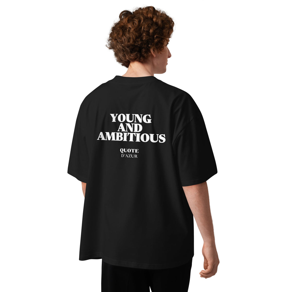 Young and Ambitious – Oversized T-Shirt in Black, back view on a male model.