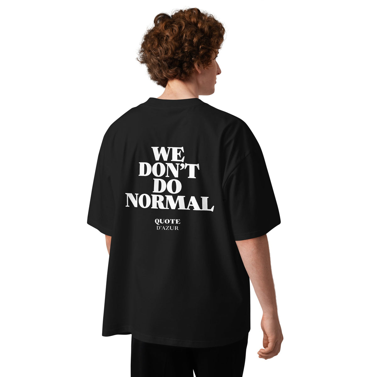 We Don’t Do Normal – Oversized T-Shirt in Black, back view on a male model.