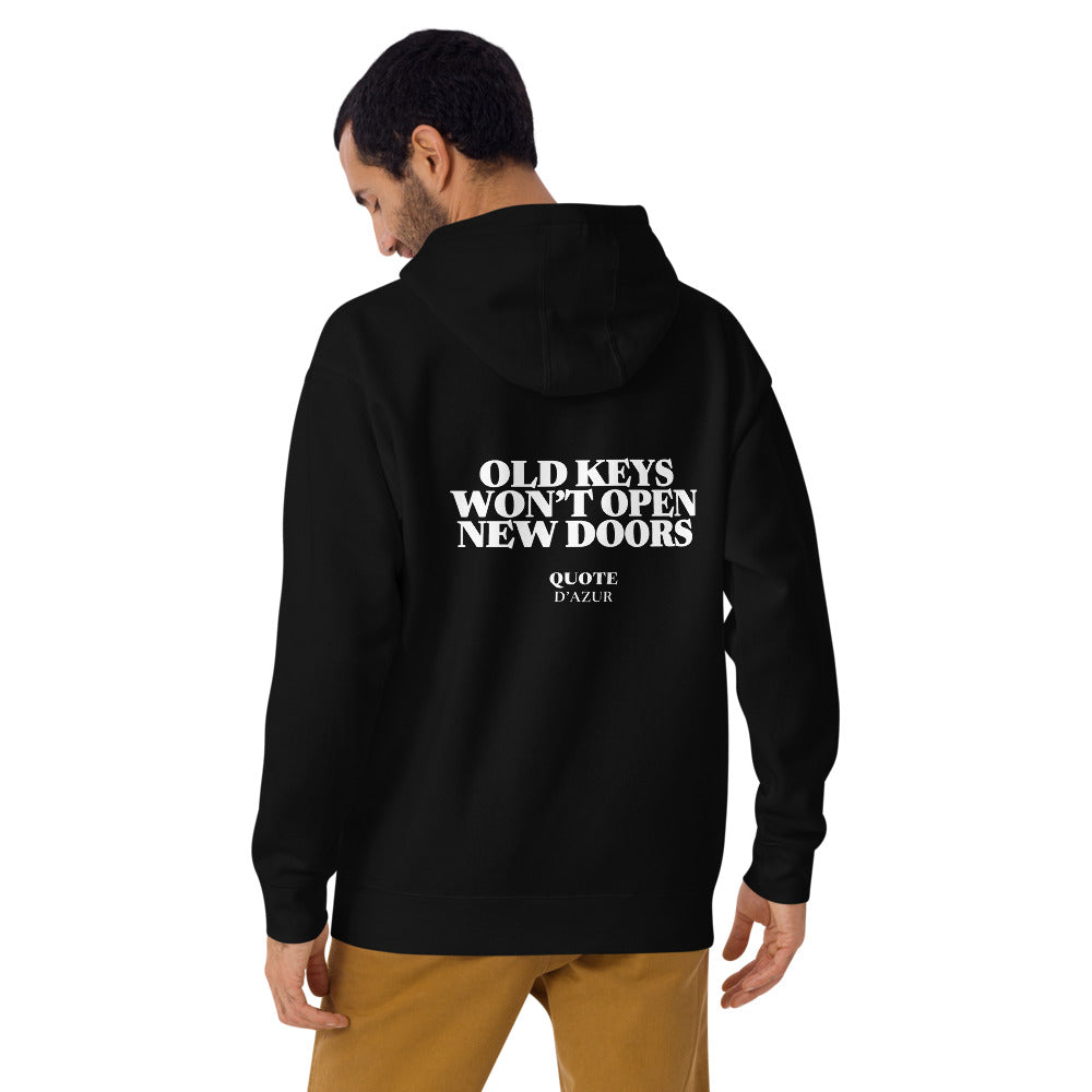 Old Keys Won’t Open New Doors – Premium Hoodie in Black, back view on a male model.